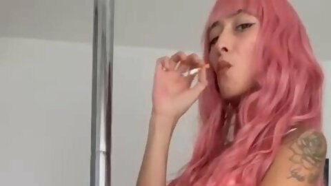 A sweet girl dances sexy while smoking